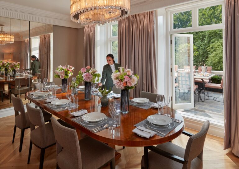 A suite dining room with a long polished table set for ten, opening onto a terrace, Mandarin Oriental Hyde Park