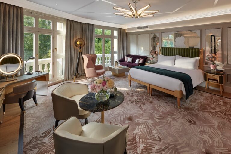 A large suite bedroom with a seating area, a dressing table and windows on two sides, Mandarin Oriental Hyde Park