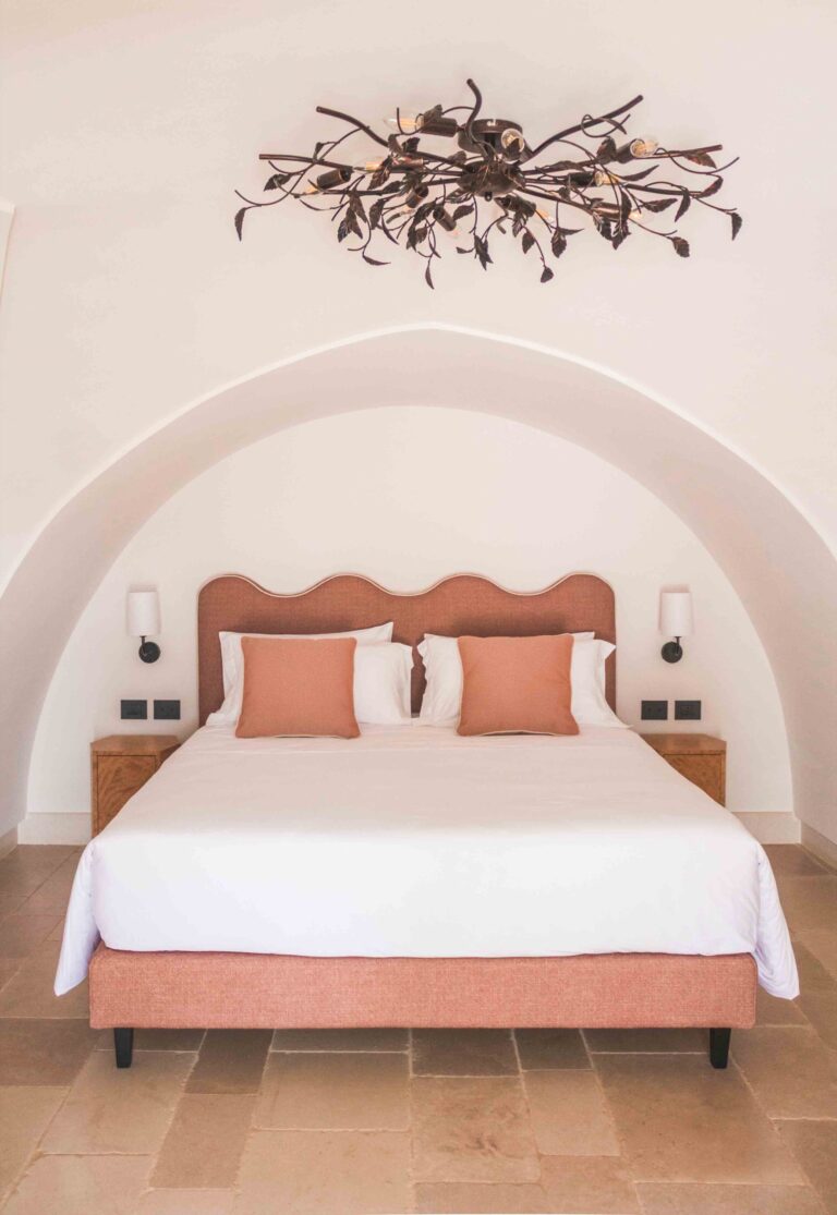 Bed under the star vault with a wrought-iron ceiling light, Superior Attic Double Room, Masseria Don Luigi