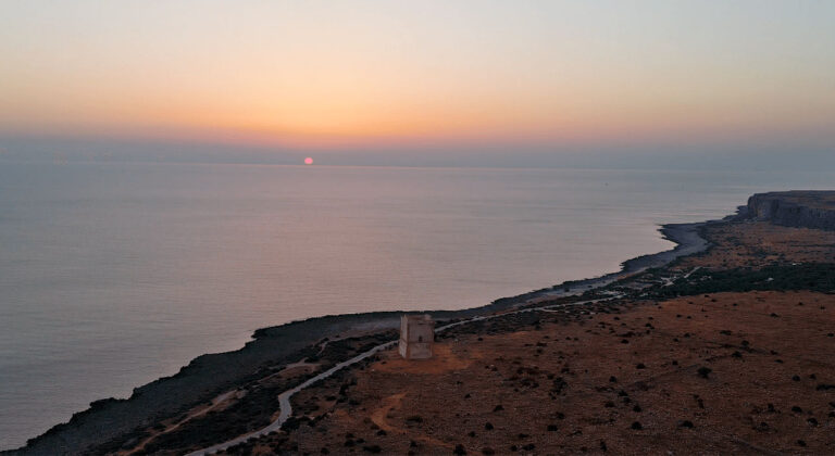 The Isulidda tower on the headland at sunset over the sea, Pittalumari Makari