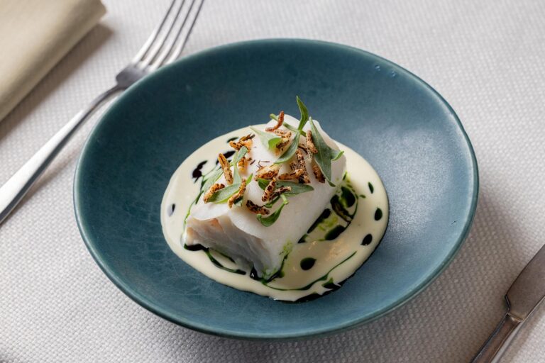 A fish dish with a pale sauce in a blue bowl, Plaisterers' Hall