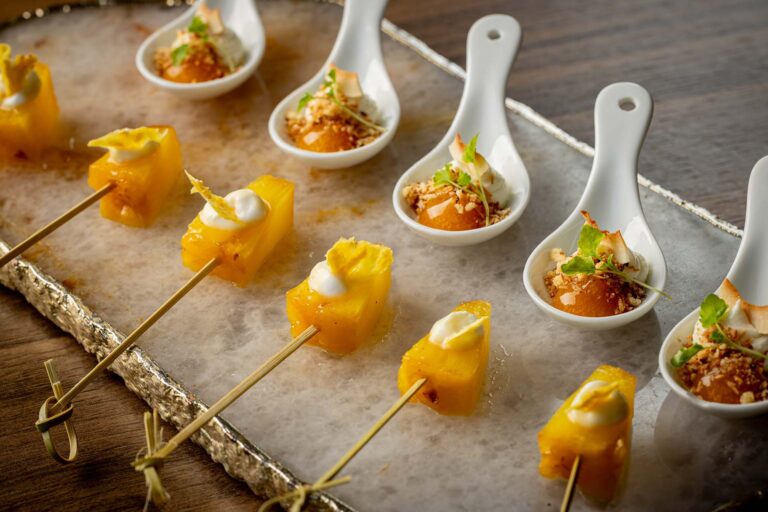 Canapés served on spoons and skewers on a stone board, Plaisterers' Hall
