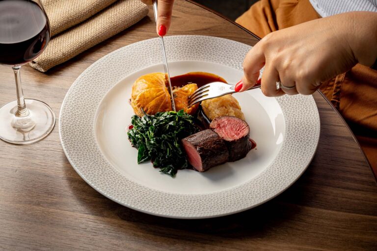 A beef main course with greens and a glossy sauce, with a glass of red wine, Plaisterers' Hall