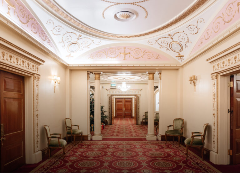 A painted and moulded ceiling above an open doorway leading through to an adjoining room, Plaisterers' Hall