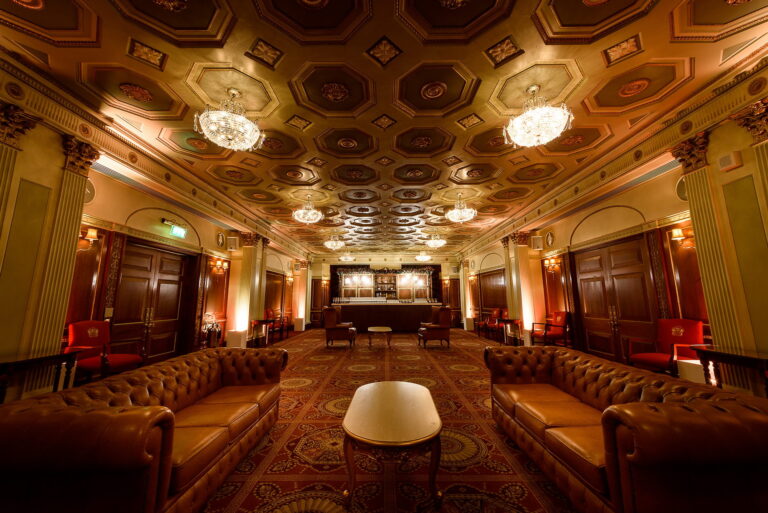The Livery Hall set as a lounge, with leather sofas beneath a coffered ceiling and chandeliers, Plaisterers' Hall