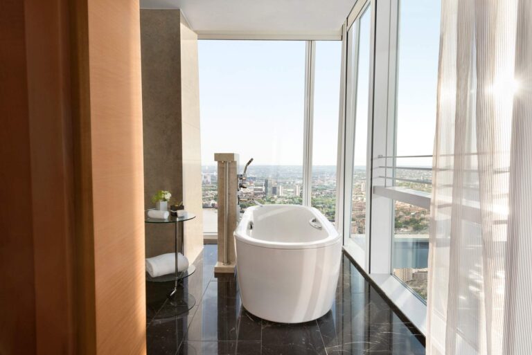 A freestanding bath set against the glass in an Iconic Shard Suite bathroom, Shangri-La The Shard, London