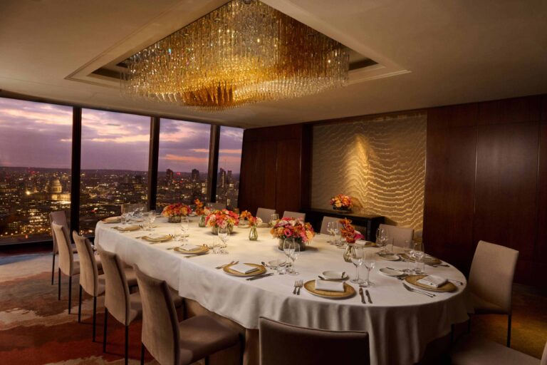 A private dining space at dusk, its oval table facing St Paul's Cathedral through the glass, Shangri-La The Shard, London