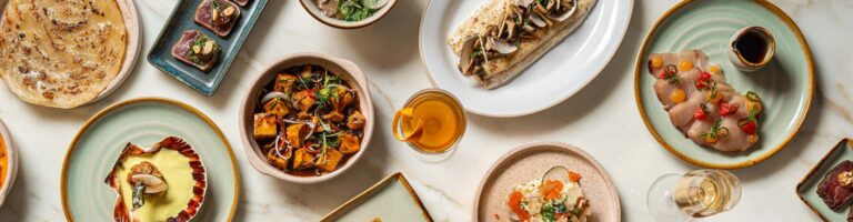 Sharing plates from TING laid out on a marble table, from scallops to a flatbread, Shangri-La The Shard, London