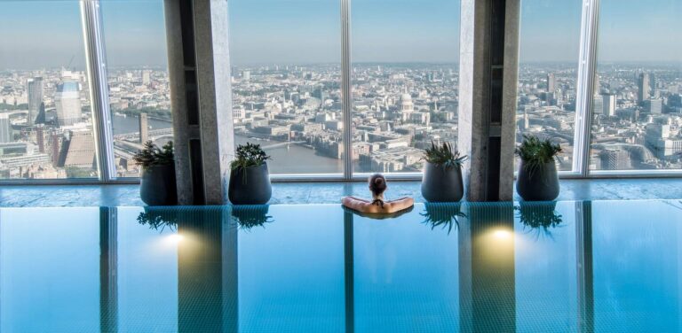A swimmer at the edge of the level 52 Sky Pool, looking out across London, Shangri-La The Shard, London