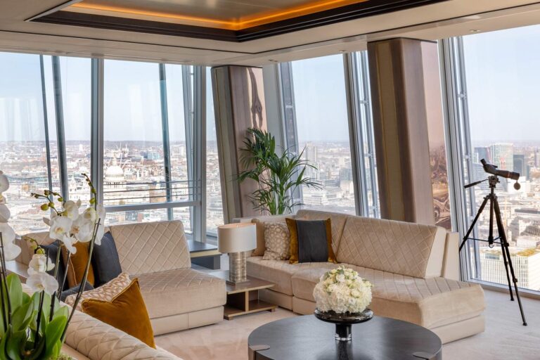 The living room of the Shangri-La Suite, with cream sofas, a telescope and views across the city, Shangri-La The Shard, London