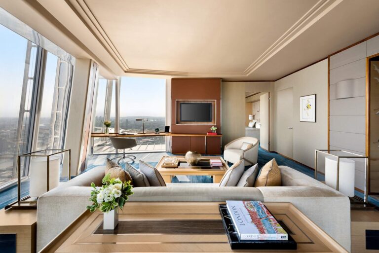 The London Suite living room with a long sofa and windows looking over the city, Shangri-La The Shard, London