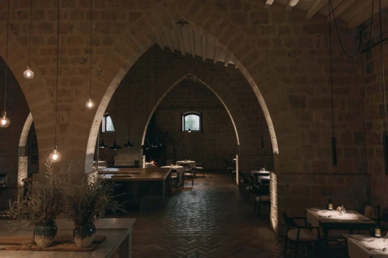 Semente restaurant under the pointed stone arches of the old granary, with pendant lights, Susafa