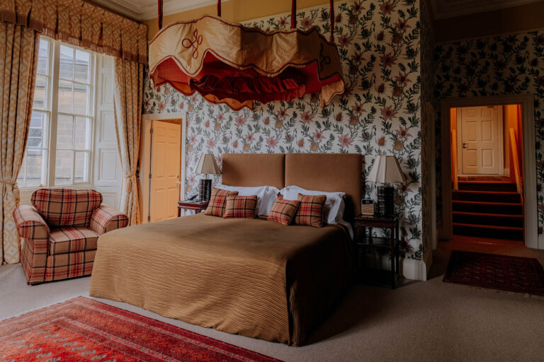 The York Suite, with a draped canopy over the bed and floral wallpaper, Swinton Park