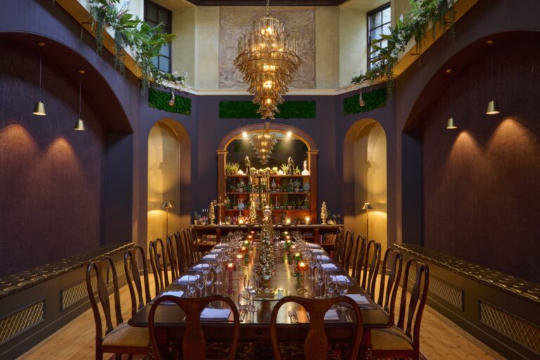Adam's Folly, the private dining room, with a long table beneath a high ceiling and chandelier, Swinton Park
