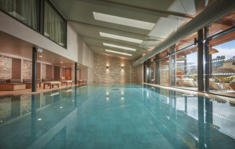 The indoor pool at Swinton Country Club and Spa, with loungers along a glazed wall, Swinton Park