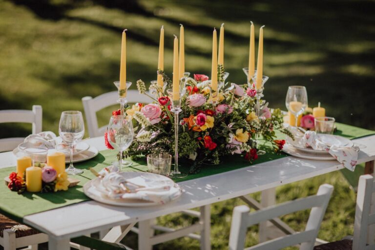 A table on the lawn dressed with candles and bright flowers, Tenuta Pinto
