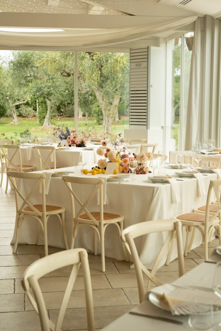 The barn (il fienile) laid with round tables beside tall windows onto the olive trees, Tenuta Pinto
