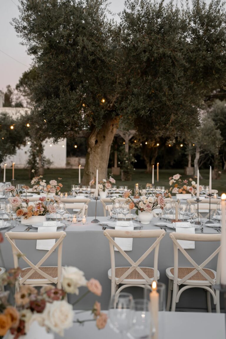 Dinner tables with candles and flowers beneath the olive trees, Tenuta Pinto