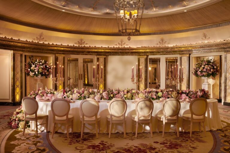 A long table with a garland of pink flowers in the Gold and Silver Room, The Dorchester