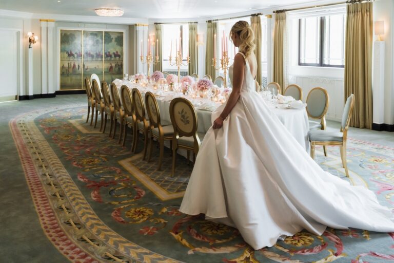A long table in the Park Suite beside windows, with a figure in a wedding gown in the foreground, The Dorchester