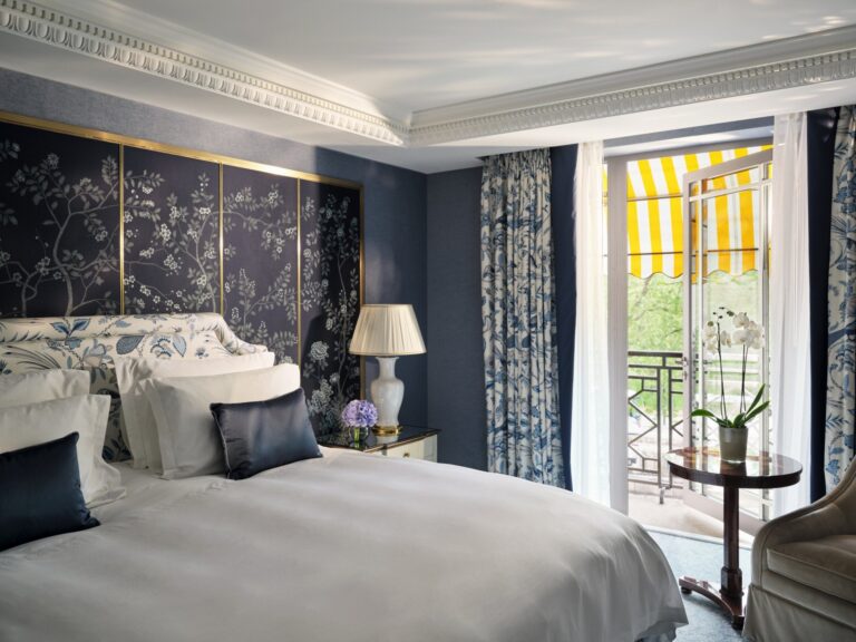 A Hyde Park Suite bedroom with a navy painted wall and a balcony beyond the curtains, The Dorchester
