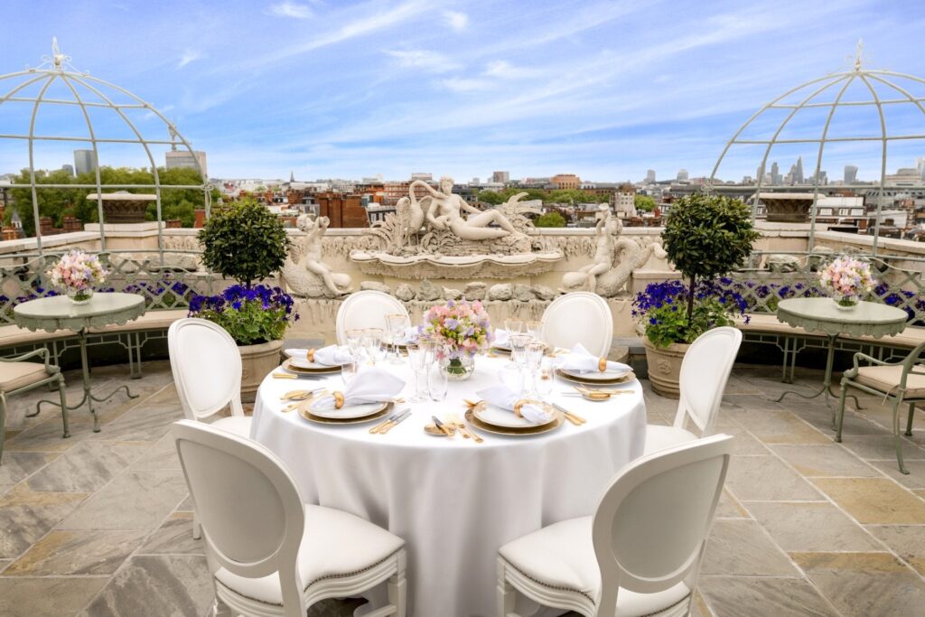 A table set for lunch on the Pavilion roof terrace, with the London skyline beyond, The Dorchester