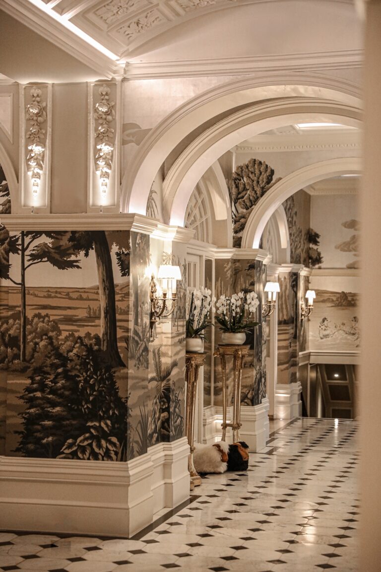 An arched corridor with marble columns and a black and white chequered floor, The Goring