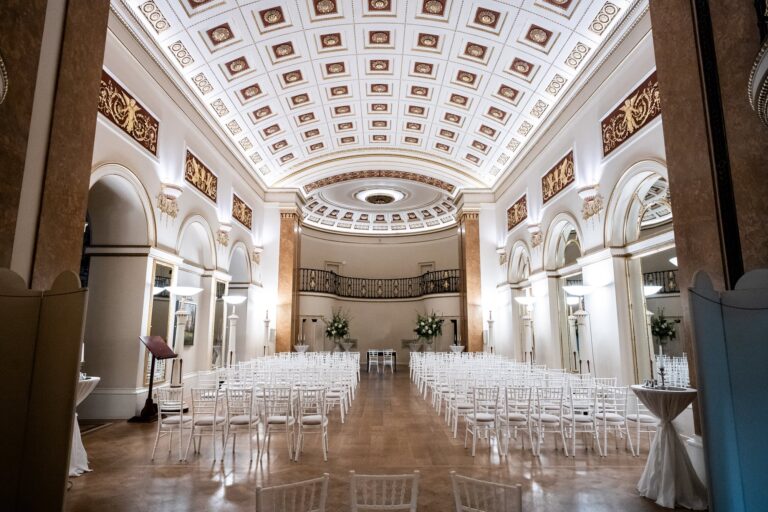 The Ballroom set with rows of white chairs for a ceremony, under the coffered vaulted ceiling, The Lansdowne Club