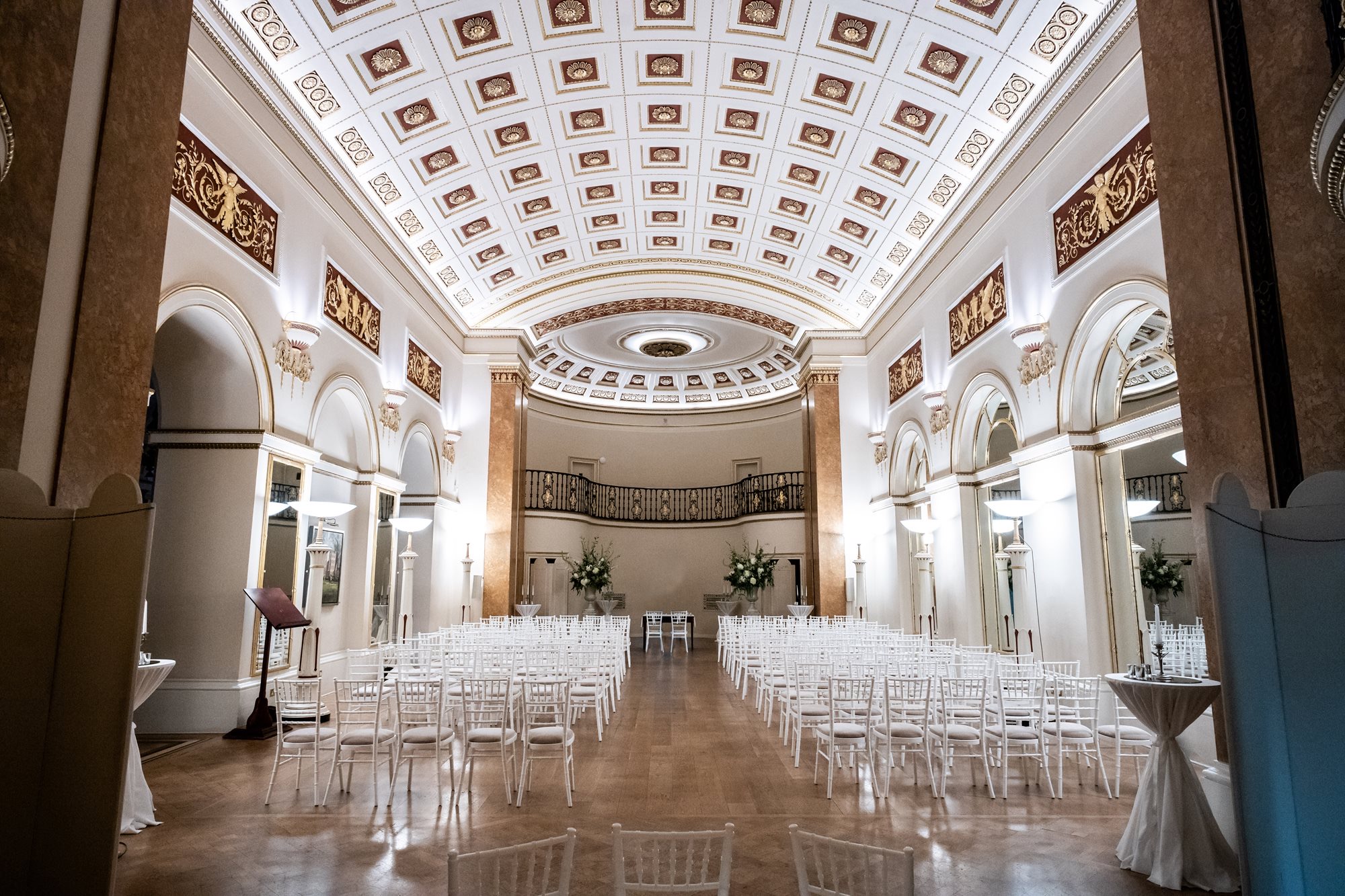 The Ballroom set with rows of white chairs for a ceremony, under the coffered vaulted ceiling, The Lansdowne Club