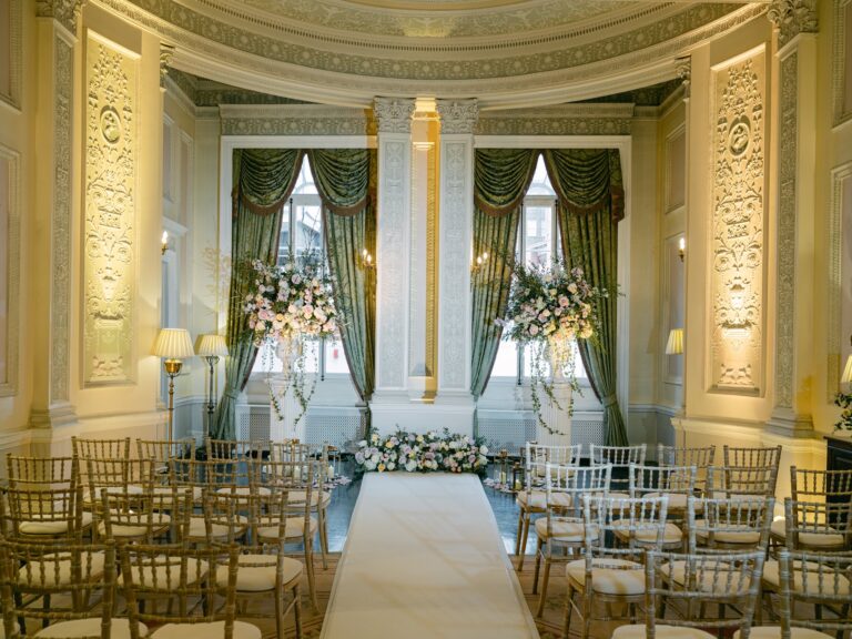 Rows of gold chairs facing tall curtained windows in the Adam Room, The Lansdowne Club