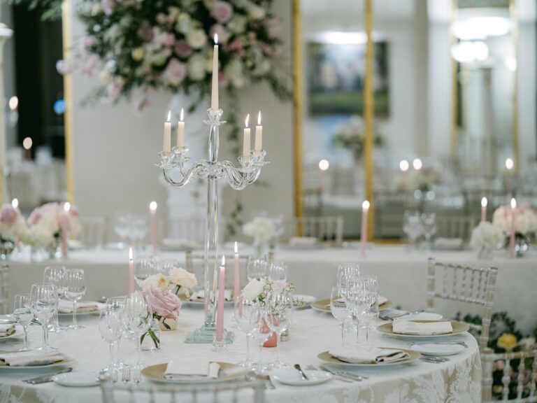 A round table with a glass candelabra, pink candles and roses, The Lansdowne Club