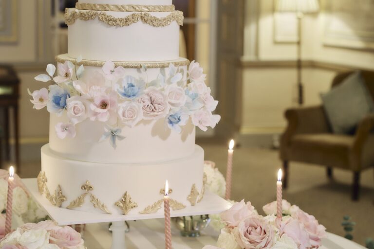 A tiered white wedding cake decorated with sugar flowers, The Lansdowne Club