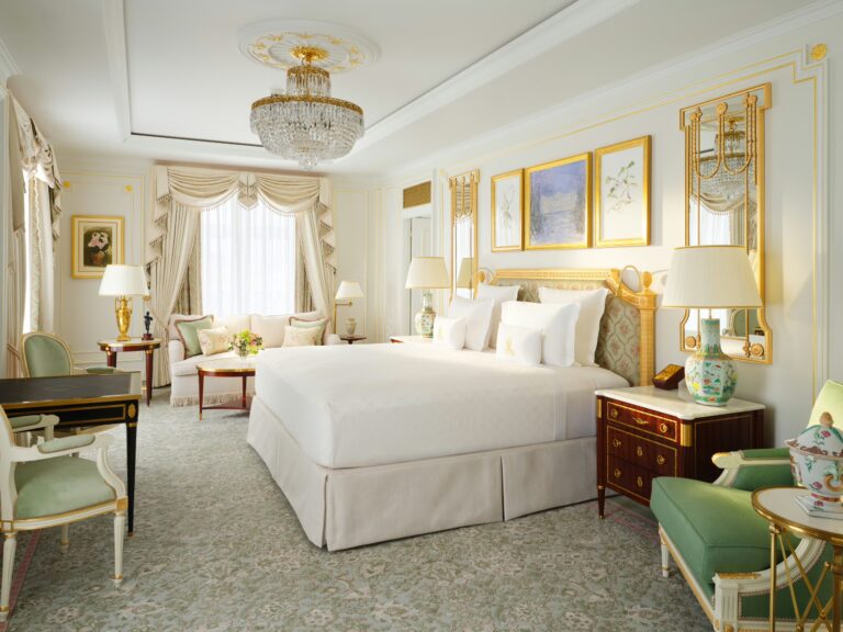 A Grand Deluxe Room with green chairs, a writing desk and a chandelier, The Ritz London