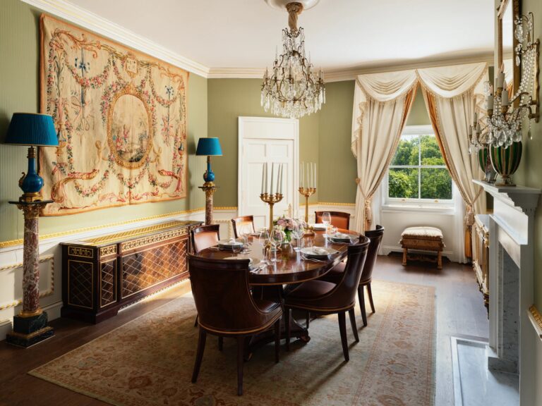 The dining room of the Prince of Wales Suite, a round table beneath a large tapestry, The Ritz London