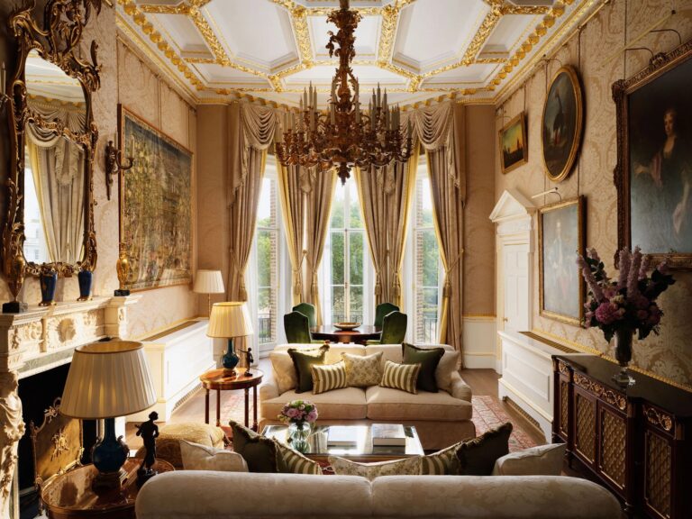 The lounge of the Royal Suite, with a gilded ceiling, chandelier and sofas, The Ritz London