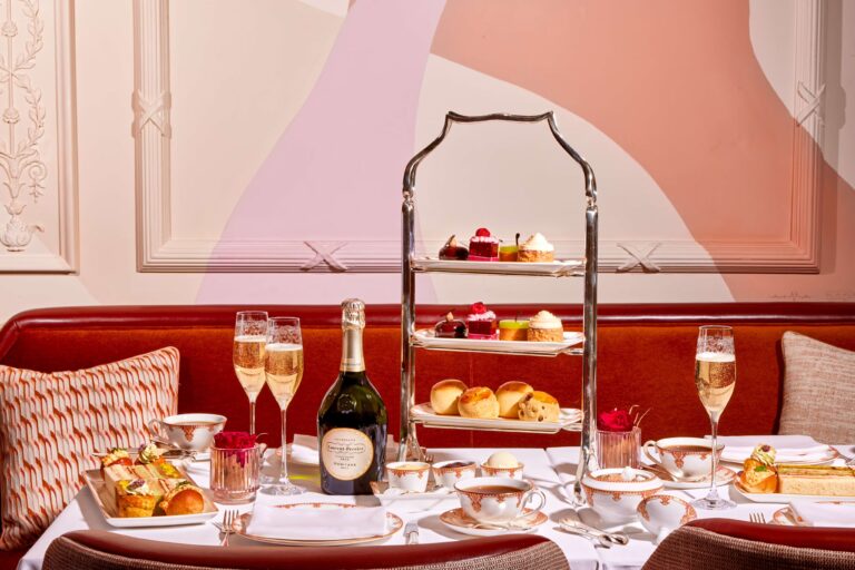 Afternoon tea with Champagne laid on a red banquette table, The Savoy