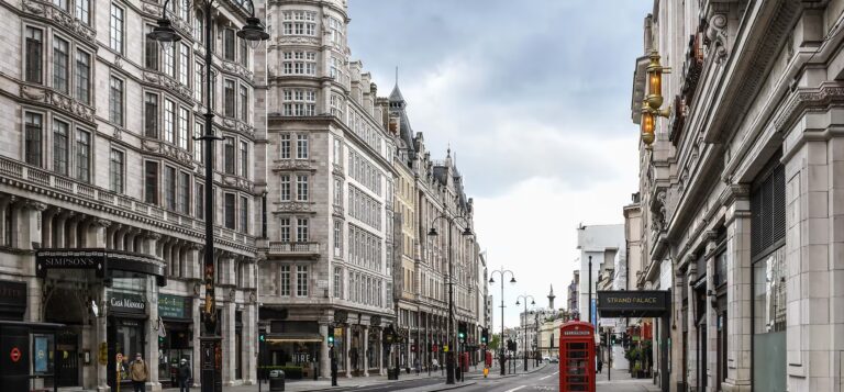The Strand outside the hotel, lined with stone buildings and a red telephone box, The Savoy