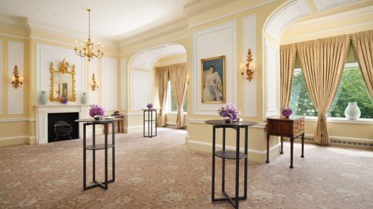 Princess Ida & Patience, a cream Edwardian-style room with a gilt mirror, portraits and windows onto trees, The Savoy