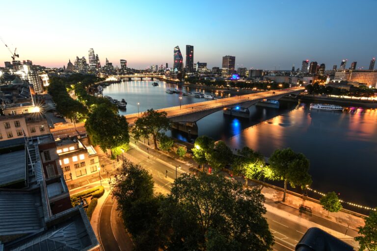 The river and Victoria Embankment lit up at dusk, seen from above, The Savoy