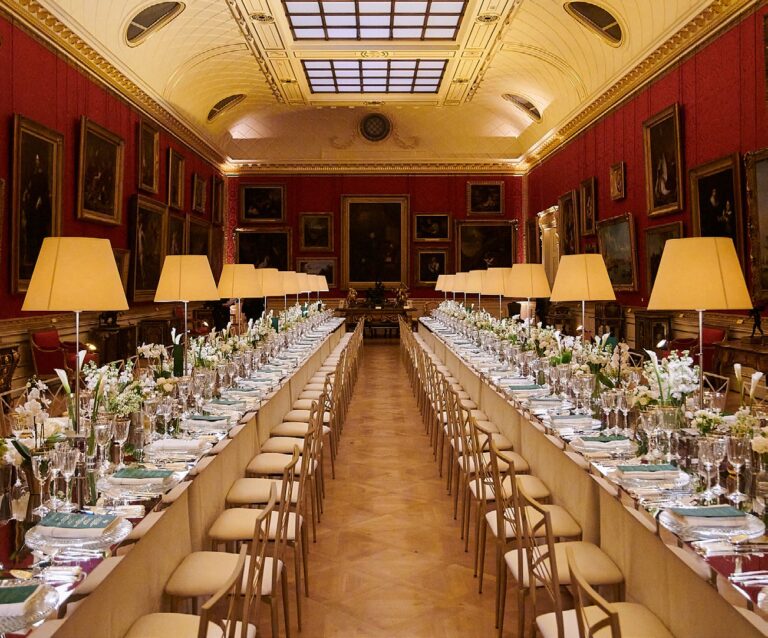 Long tables lit by table lamps running the length of a skylit gallery, The Wallace Collection