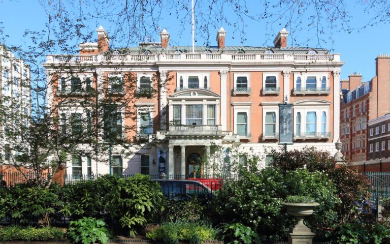 Hertford House in spring, seen past trees and planting in front of the house, The Wallace Collection