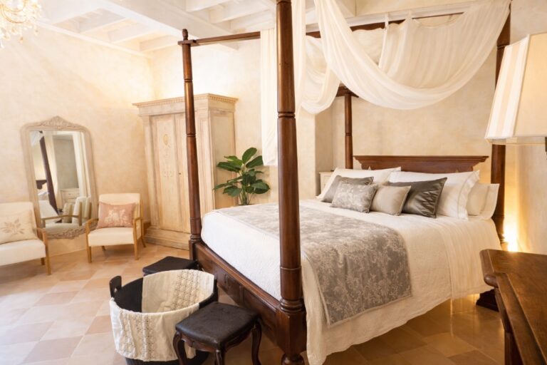 The Puccini deluxe suite with a four-poster bed, draped canopy and painted wardrobe, Torre Collevento