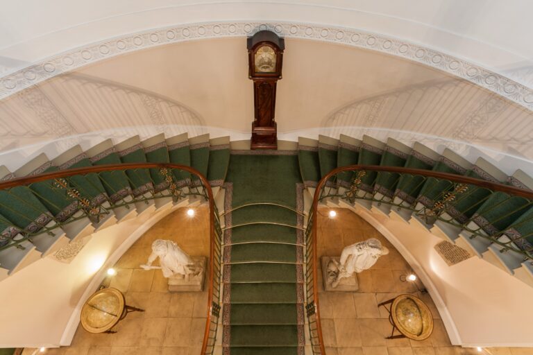 The twin staircase from the upper landing, with its green runner and brass rails, Trinity House on Tower Hill