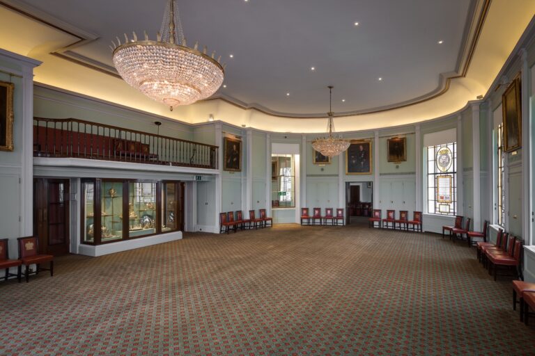 The oval Library, clear for an event, with its minstrels' gallery, silver cabinets and stained glass, Trinity House on Tower Hill