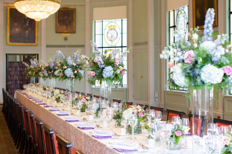 A long banqueting table in the Library dressed with tall arrangements of hydrangea and delphinium, Trinity House on Tower Hill