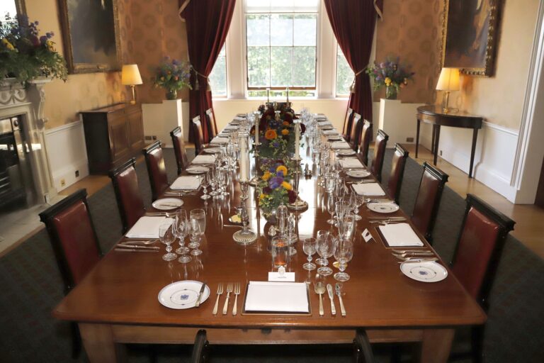 The Luncheon Room laid for a small dinner, with candlesticks and garden flowers down the table, Trinity House on Tower Hill