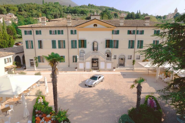 The main facade and gravel courtyard of the villa, with its double stone staircase, Villa Cariola