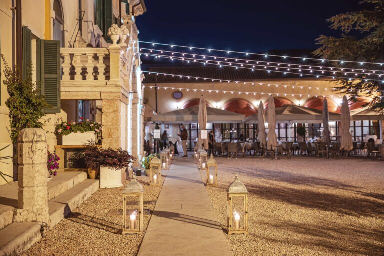 The courtyard at night, lit by lanterns and strings of lights, Villa Cariola