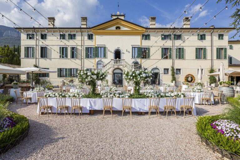 Long tables with white flowers laid in the courtyard in front of the villa, Villa Cariola