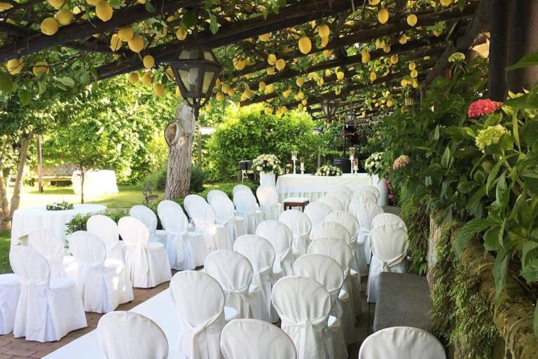 White chairs set in rows for a ceremony beneath the lemon pergola, Villa del Vecchio Pozzo in Posillipo